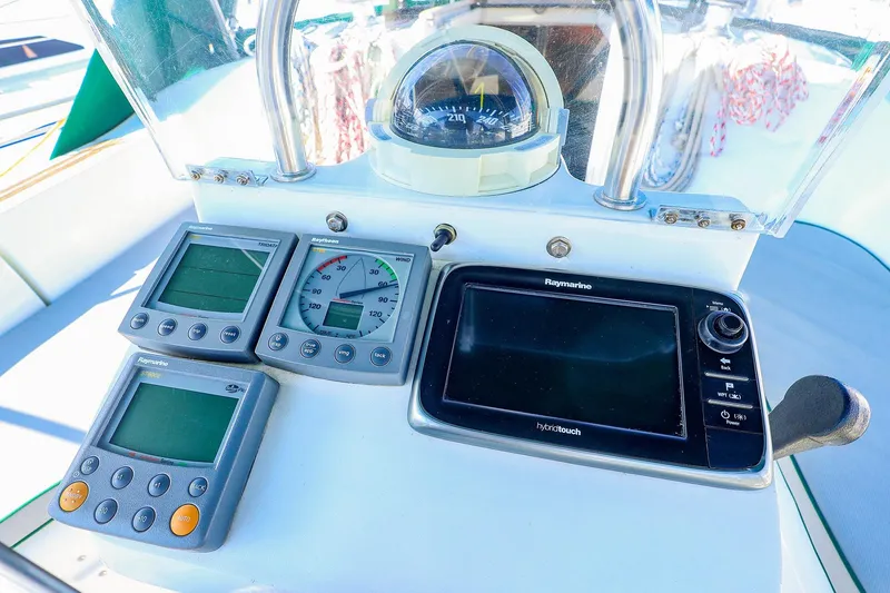 Slide: The Image of Beneteau Oceanis Clipper 361 cockpit instruments, featuring Raymarine displays and compass, 2002 model. - 11