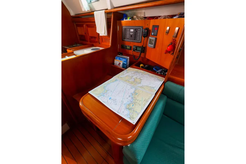 Slide: The Image of Navigation station on 2002 Beneteau Oceanis Clipper 361 with nautical chart and instruments. - 47