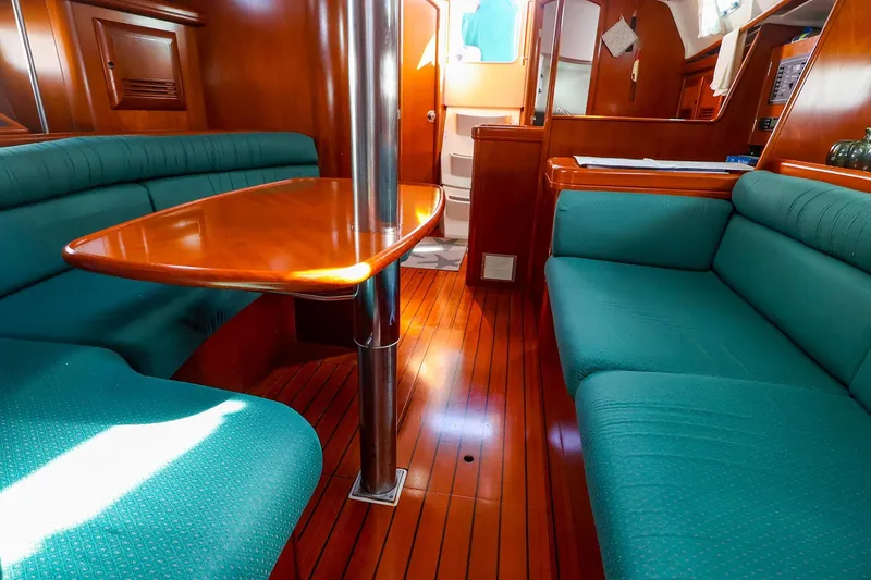 Slide: The Image of Interior of 2002 Beneteau Oceanis Clipper 361 yacht with wooden flooring and teal seating. - 43