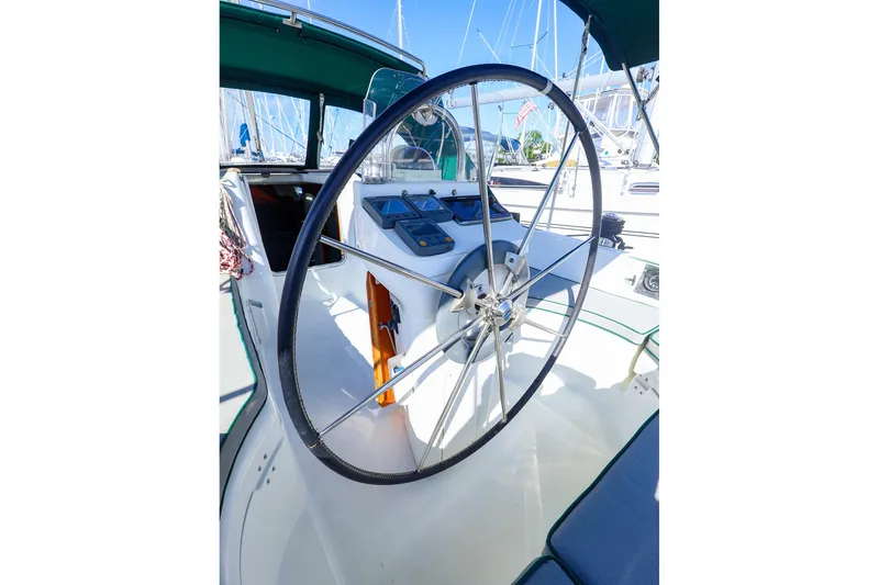 Slide: The Image of Steering wheel of a 2002 Beneteau Oceanis Clipper 361 sailboat in a marina. - 14