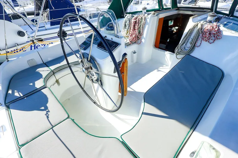 Slide: The Image of Cockpit of 2002 Beneteau Oceanis Clipper 361 sailboat with steering wheel and seating. - 12