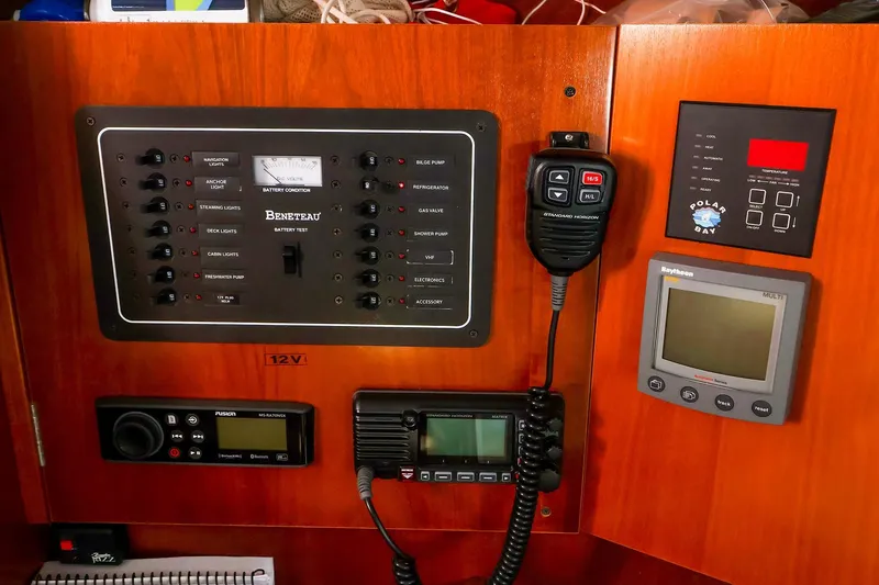 Slide: The Image of Control panel of a 2002 Beneteau Oceanis Clipper 361 sailboat, featuring navigation and communication equipment. - 48