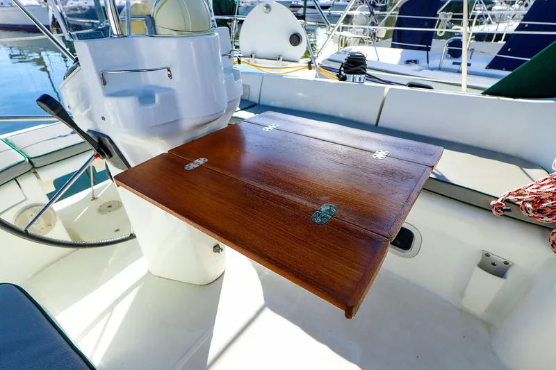 Slide: The Image of Cockpit of 2002 Beneteau Oceanis Clipper 361 with wooden folding table and steering wheel. - 15