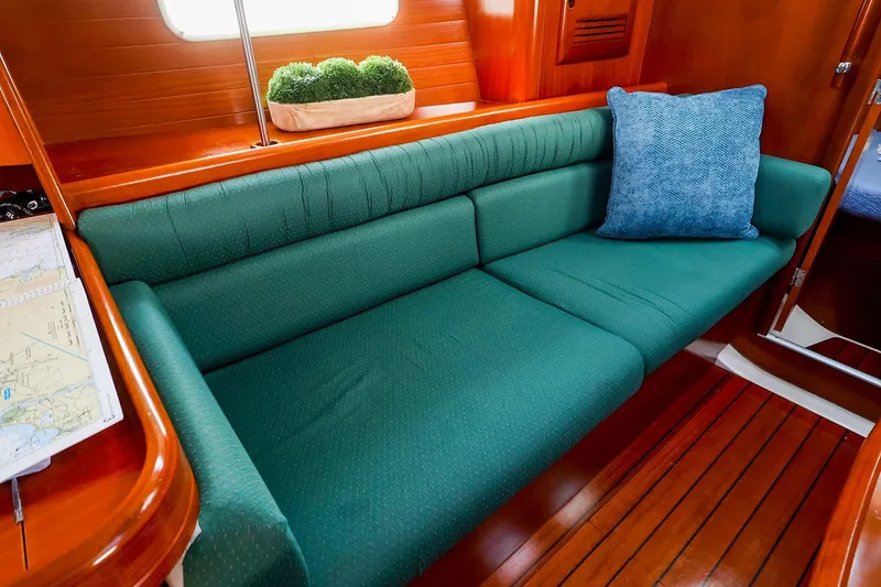 Slide: The Image of Interior of 2002 Beneteau Oceanis Clipper 361 with green sofa and blue cushion. - 40