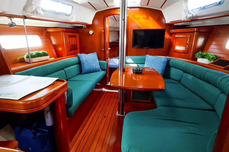 Slide: The Image of Interior of 2002 Beneteau Oceanis Clipper 361 yacht with cozy seating and wooden finishes. - 38