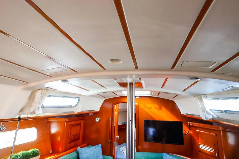 Slide: The Image of Interior of 2002 Beneteau Oceanis Clipper 361 yacht, featuring wood paneling and modern amenities. - 53