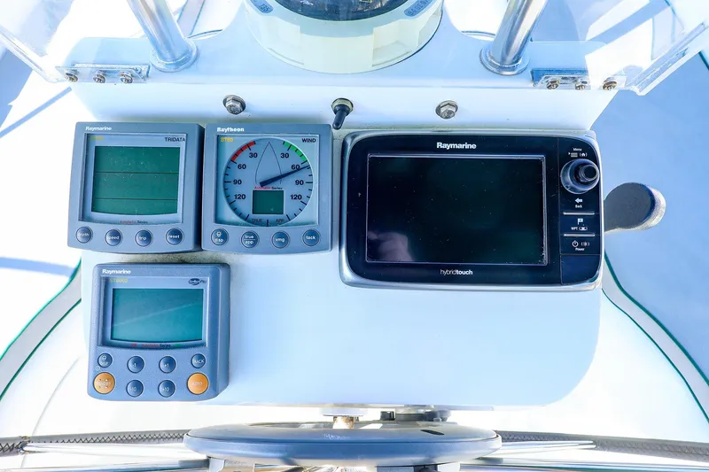 Slide: The Image of Cockpit instruments of a 2002 Beneteau Oceanis Clipper 361 sailboat, featuring Raymarine displays. - 10