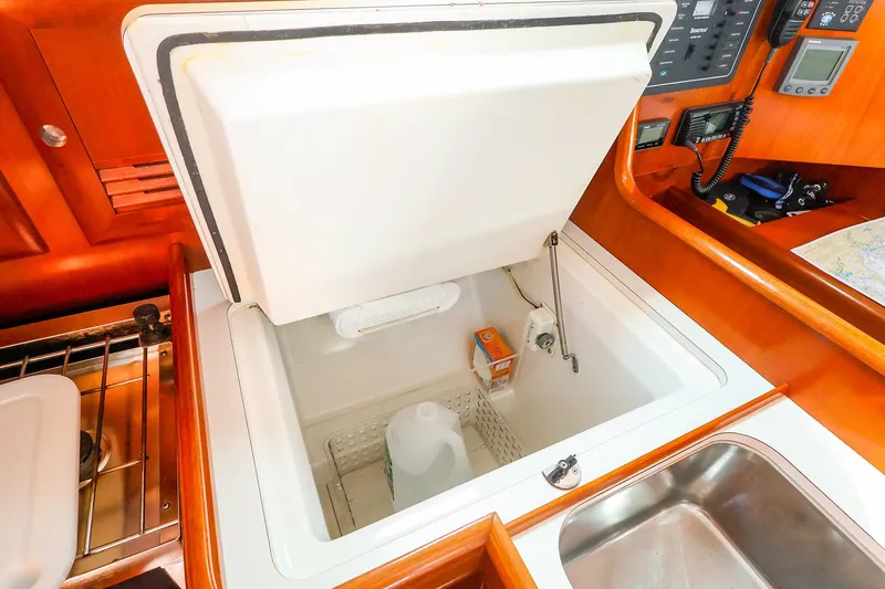 Slide: The Image of Interior of 2002 Beneteau Oceanis Clipper 361 yacht showing open fridge and navigation equipment. - 52