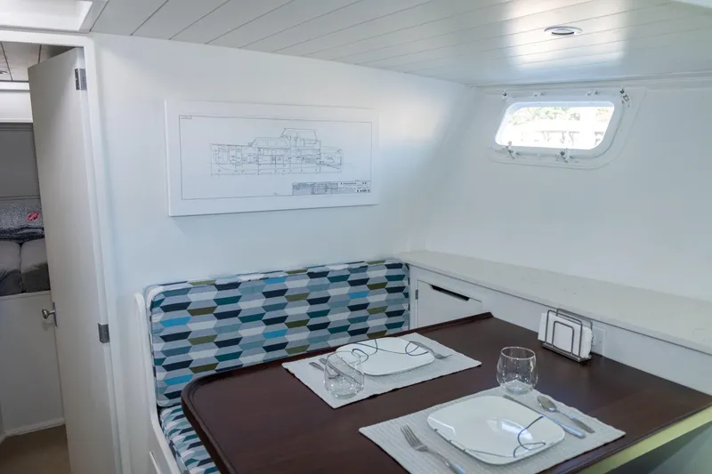 Slide: The Image of Interior of 1967 Huckins Linwood 53 yacht with dining area and geometric-patterned seating. - 20