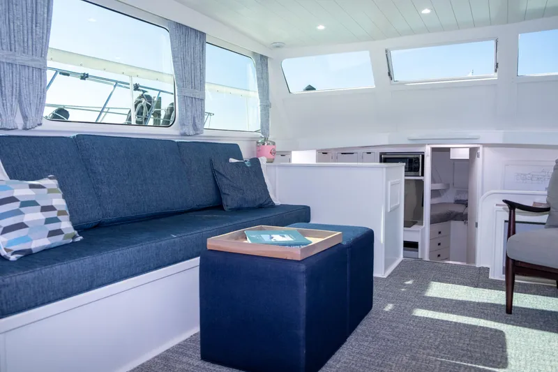 Slide: The Image of Interior of 1967 Huckins Linwood 53 yacht with blue seating and modern decor. - 17
