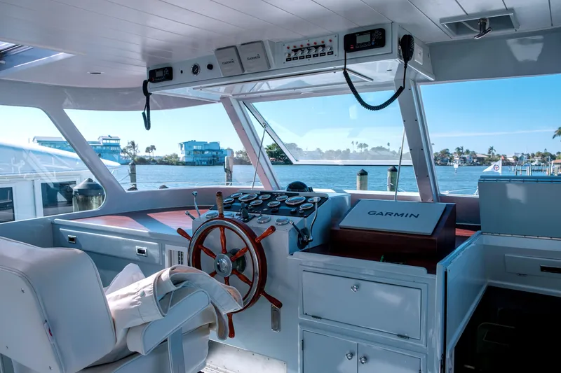 Slide: The Image of Interior of a 1967 Huckins Linwood 53 yacht with steering wheel and navigation equipment. - 7