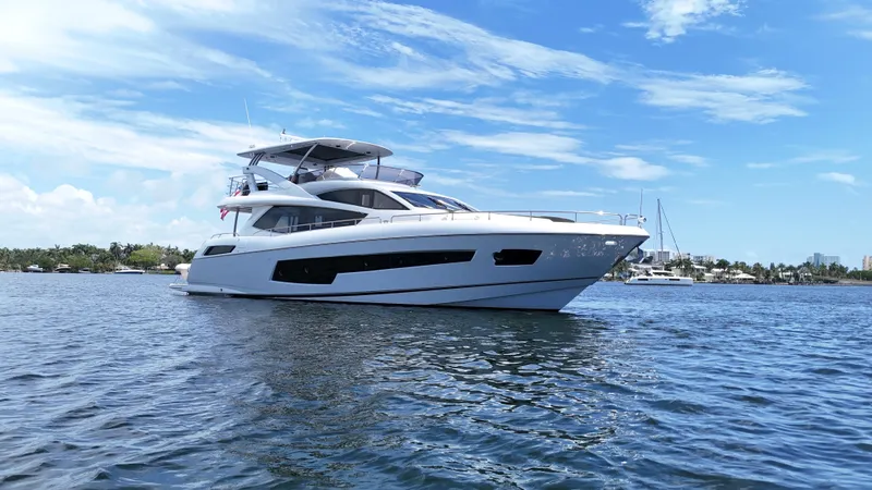 The Image of 2017 Sunseeker 75 Yacht on calm water under a clear blue sky. - 0