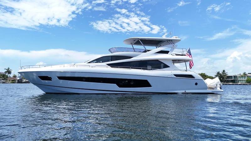 Slide: The Image of 2017 Sunseeker 75 Yacht on calm water under a clear blue sky. - 2
