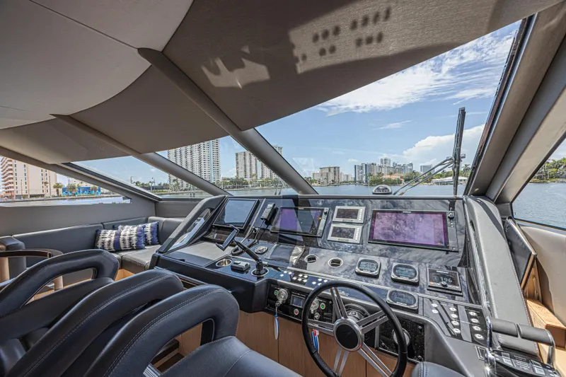 Slide: The Image of Luxurious 2017 Sunseeker 75 Yacht helm with modern navigation equipment and panoramic city views. - 37