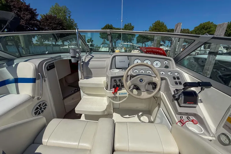 Slide: The Image of 2001 Formula 280 Sun Sport boat cockpit with steering wheel and control panel. - 11