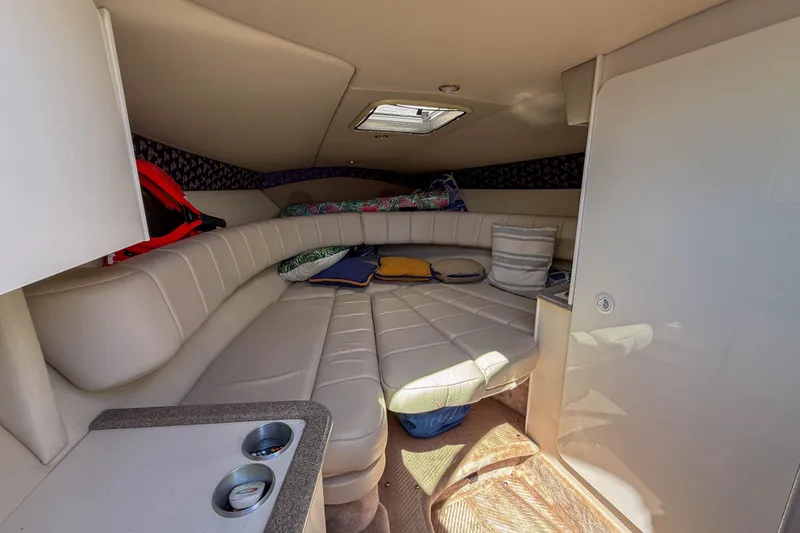 Slide: The Image of Interior cabin of 2001 Formula 280 Sun Sport boat with cushioned seating and storage. - 16