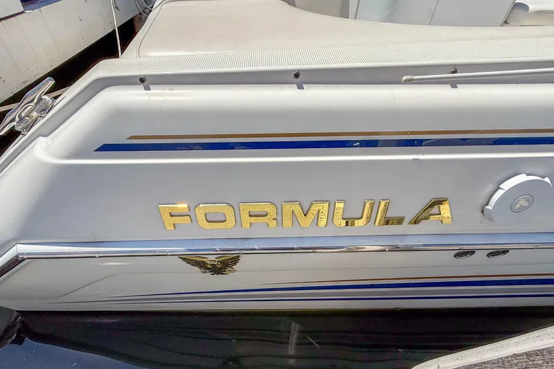 Slide: The Image of 2001 Formula 280 Sun Sport boat with gold lettering and sleek design. - 6