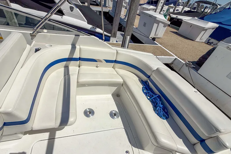 Slide: The Image of 2001 Formula 280 Sun Sport boat interior with white and blue seating at a marina. - 7