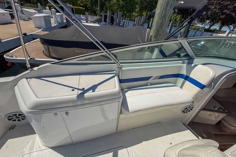 Slide: The Image of 2001 Formula 280 Sun Sport boat interior with white seating and storage area. - 9