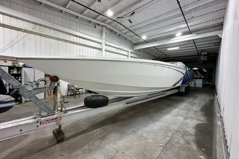Slide: The Image of 2000 Cigarette 42' Tiger boat on trailer in indoor storage facility. - 1