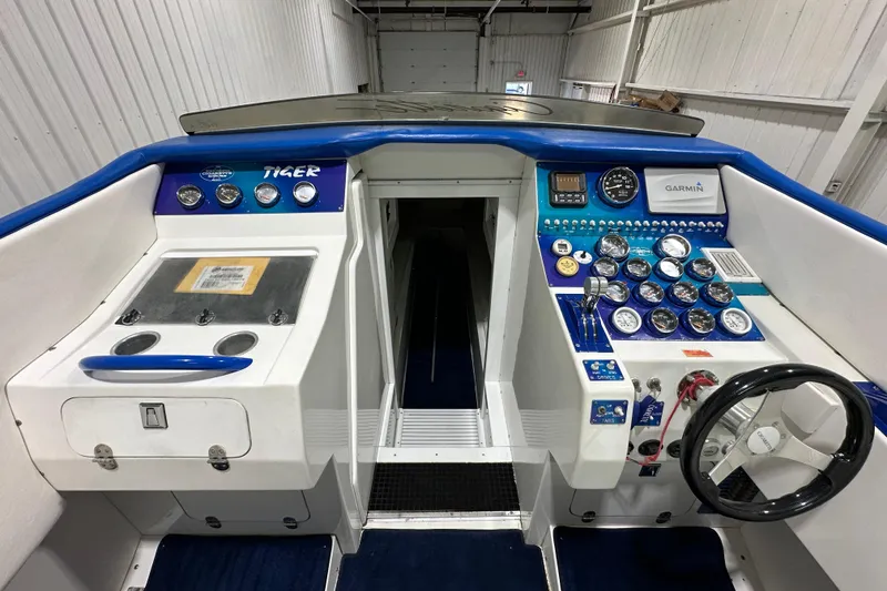 Slide: The Image of Cockpit of a 2000 Cigarette 42' Tiger boat with gauges and controls. - 12