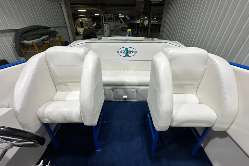 Slide: The Image of Interior of a 2000 Cigarette 42' Tiger boat with white seating and blue accents. - 13