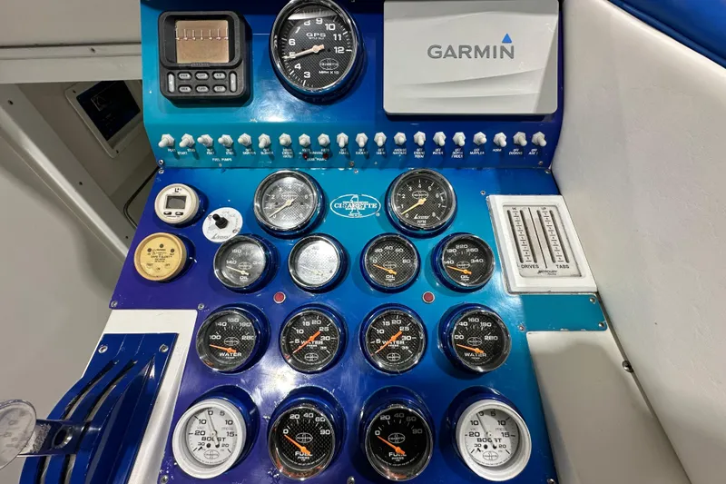 Slide: The Image of Dashboard of a 2000 Cigarette 42' Tiger boat with gauges and Garmin navigation system. - 15