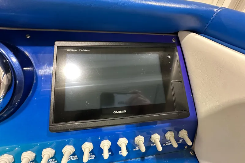 Slide: The Image of Garmin GPSMAP 7608xsv on 2000 Cigarette 42' Tiger boat dashboard with control switches. - 16