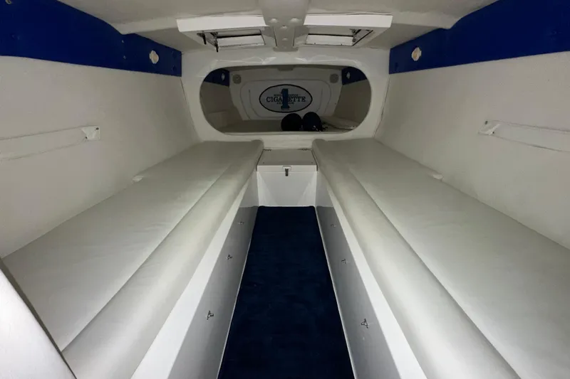 Slide: The Image of Interior cabin of a 2000 Cigarette 42' Tiger boat, featuring white seating and blue accents. - 19