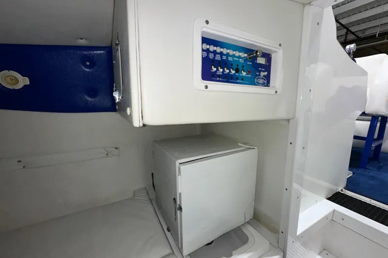Slide: The Image of Interior of a 2000 Cigarette 42' Tiger boat, featuring control panel and storage compartment. - 20