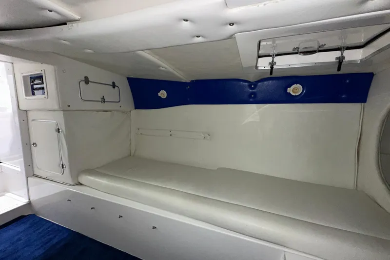 Slide: The Image of Interior cabin of a 2000 Cigarette 42' Tiger boat with white and blue accents. - 21
