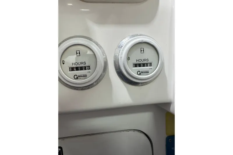 Slide: The Image of Hour meters on a 2000 Cigarette 42' Tiger boat dashboard, displaying usage hours. - 23