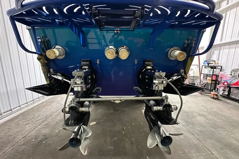 Slide: The Image of Rear view of a 2000 Cigarette 42' Tiger boat with dual propellers in a garage. - 4