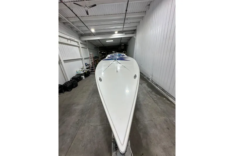 Slide: The Image of 2000 Cigarette 42' Tiger boat in a storage facility, showcasing sleek design. - 8