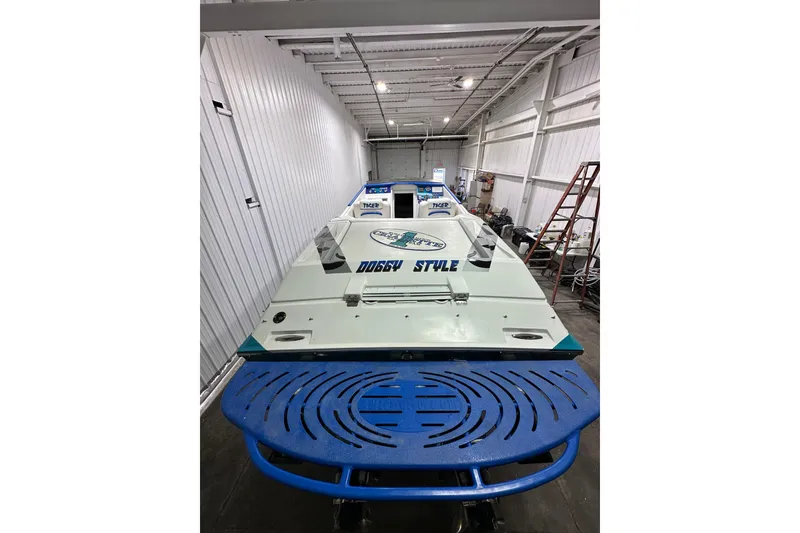 Slide: The Image of 2000 Cigarette 42' Tiger boat in storage, featuring custom graphics and sleek design. - 9