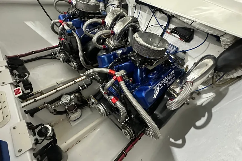 Slide: The Image of Twin Mercury Racing engines in a 2000 Cigarette 42' Tiger boat. - 25