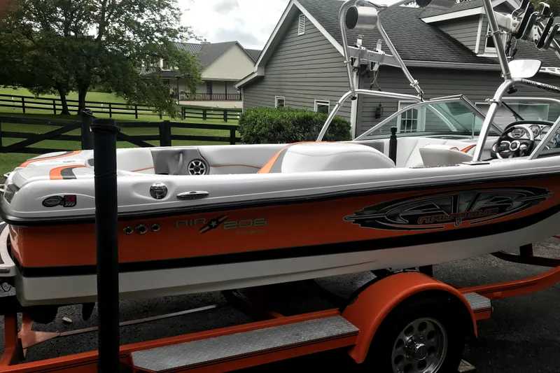 Slide: The Image of 2005 Nautique Air Nautique 206 boat on trailer, parked in residential driveway. - 1