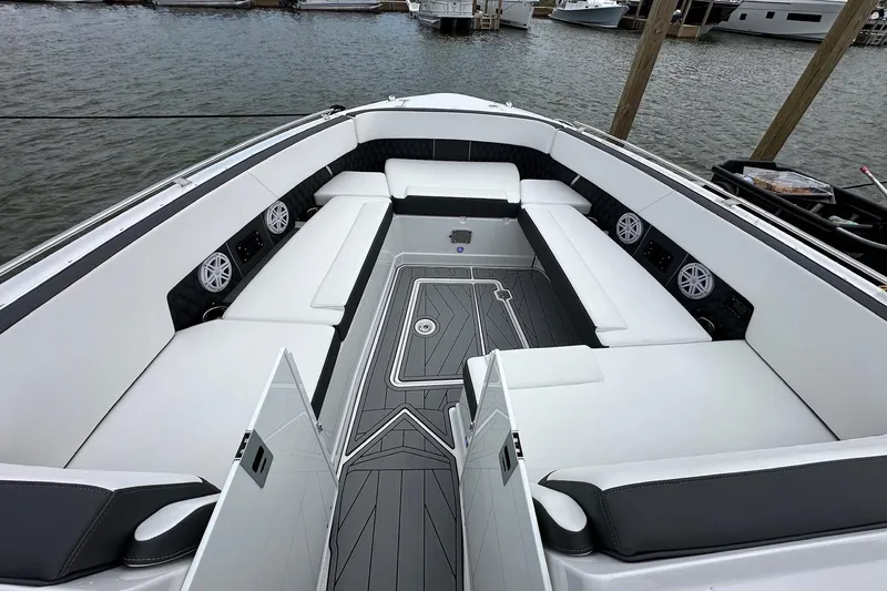Slide: The Image of Luxurious seating area on a 2023 Monterey 378SS Super Sport boat, docked by the water. - 13