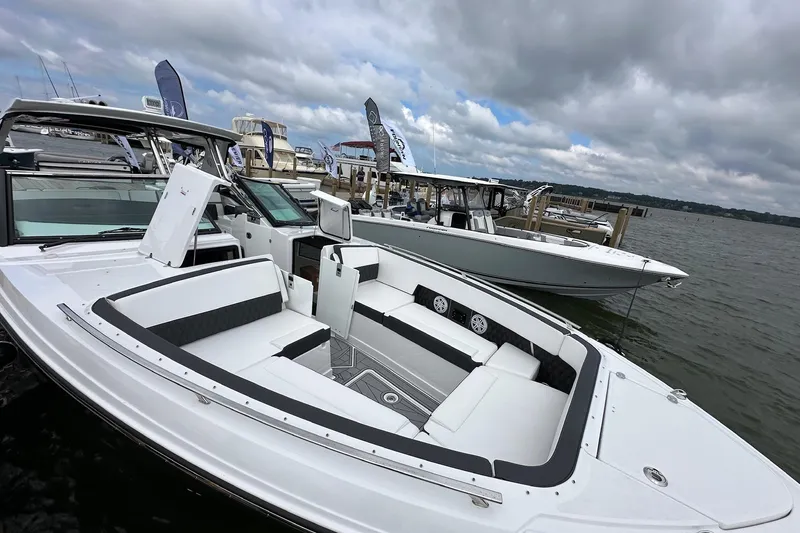 Slide: The Image of 2023 Monterey 378SS Super Sport boat docked, showcasing sleek design and spacious seating. - 14