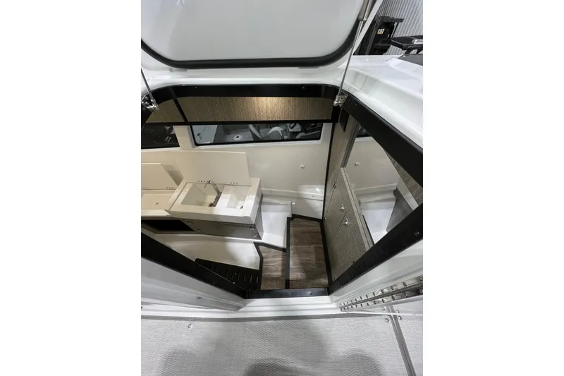 Slide: The Image of Interior view of 2023 Monterey 378SS Super Sport boat cabin with sink and stairs. - 15