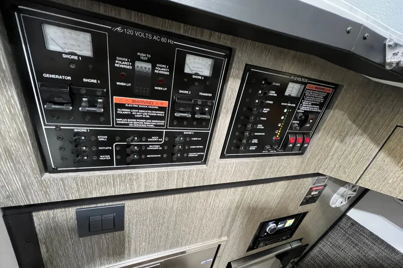 Slide: The Image of Electrical control panel of 2023 Monterey 378SS Super Sport boat, featuring various switches and gauges. - 19