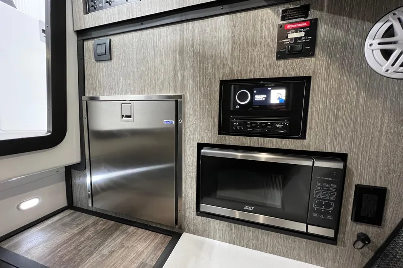 Slide: The Image of 2023 Monterey 378SS Super Sport interior with stainless appliances and modern entertainment system. - 21