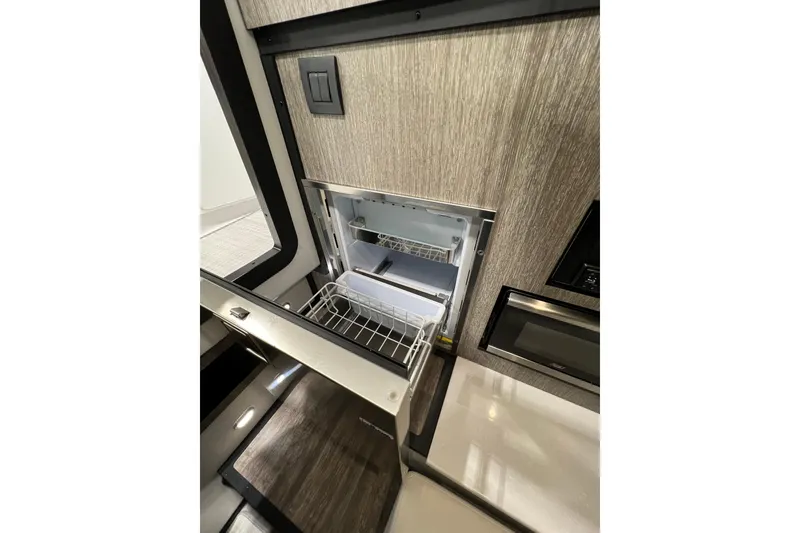 Slide: The Image of Interior view of 2023 Monterey 378SS Super Sport boat kitchen area with open fridge. - 22