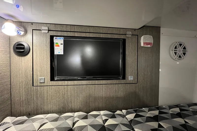 Slide: The Image of 2023 Monterey 378SS Super Sport interior with TV, modern lighting, and geometric-patterned seating. - 29