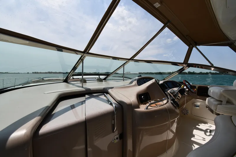 Slide: The Image of The cockpit of a 2000 Sea Ray Sundancer 460 overlooking the water. - 11