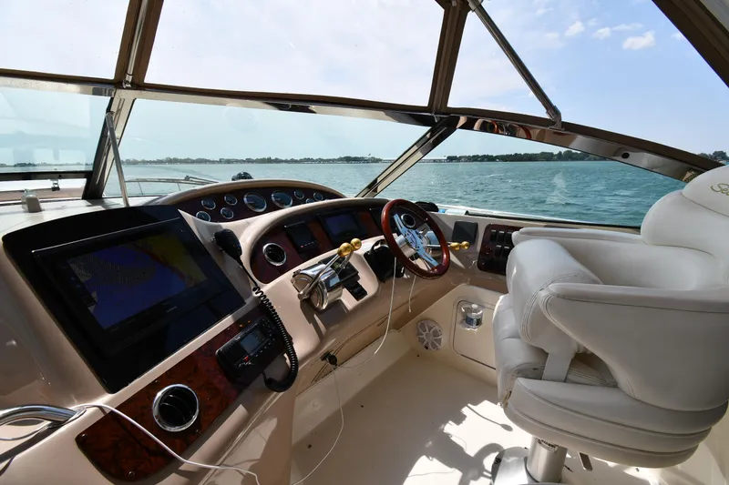 Slide: The Image of The cockpit of a 2000 Sea Ray Sundancer 460 with modern steering and instruments. - 12