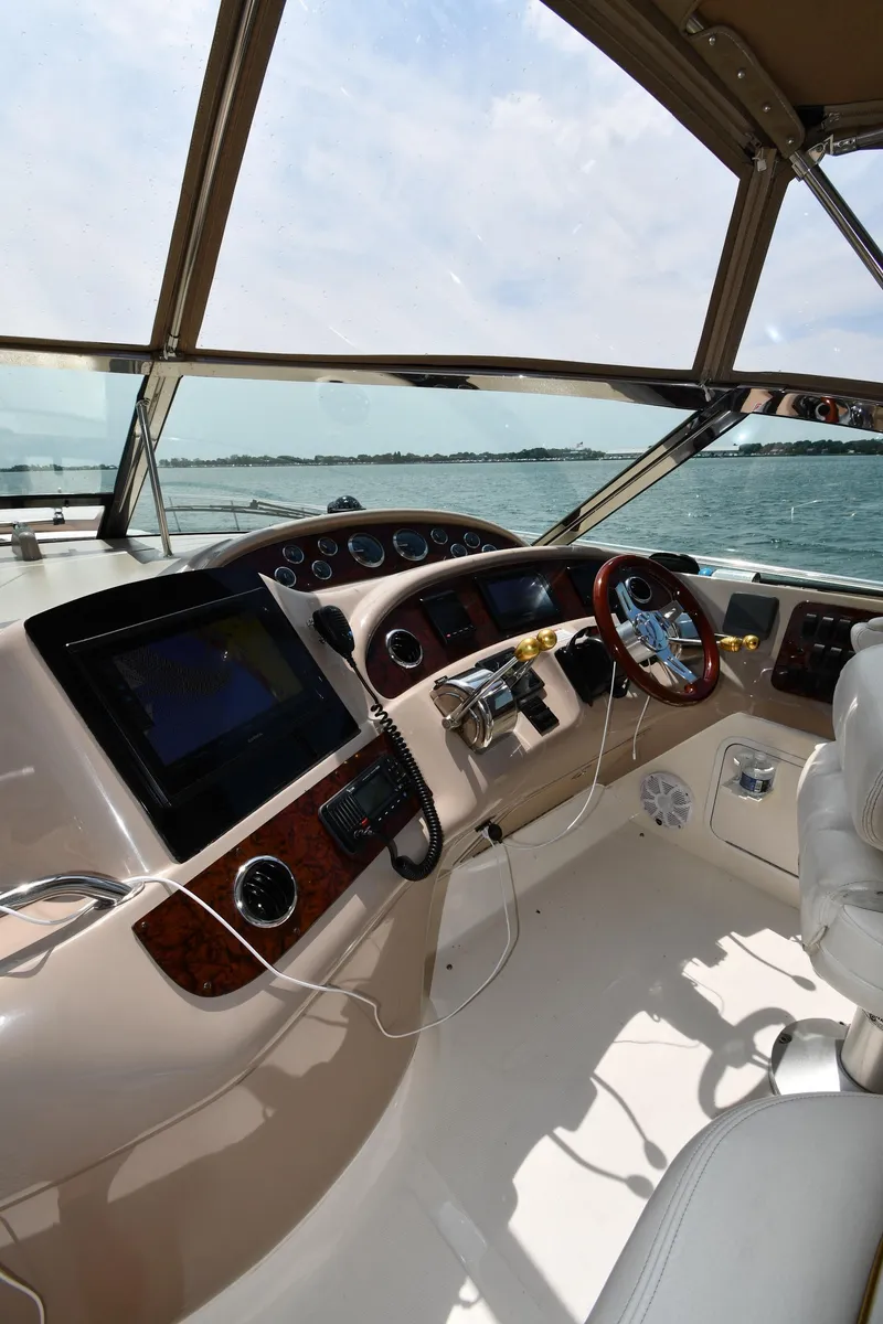 Slide: The Image of Helm of the 2000 Sea Ray Sundancer 460 overlooking the water. - 13