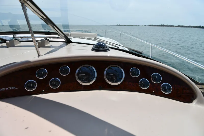 Slide: The Image of The dashboard of a 2000 Sea Ray Sundancer 460 with multiple gauges, on the water. - 17