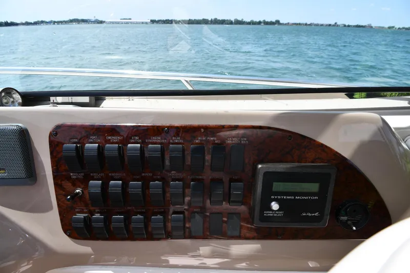Slide: The Image of The image shows the dashboard of a 2000 Sea Ray Sundancer 460 with a view of the water. - 18