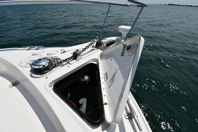 Slide: The Image of The bow of a 2000 Sea Ray Sundancer 460 with an open anchor hatch on the water. - 2